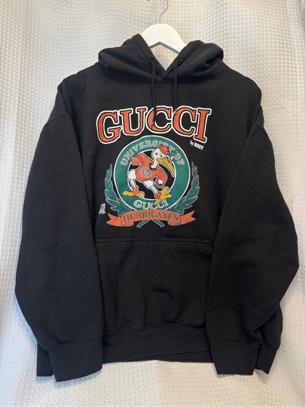Breezy Excursion Black Hoodie with Orange & Green Crest Graphic